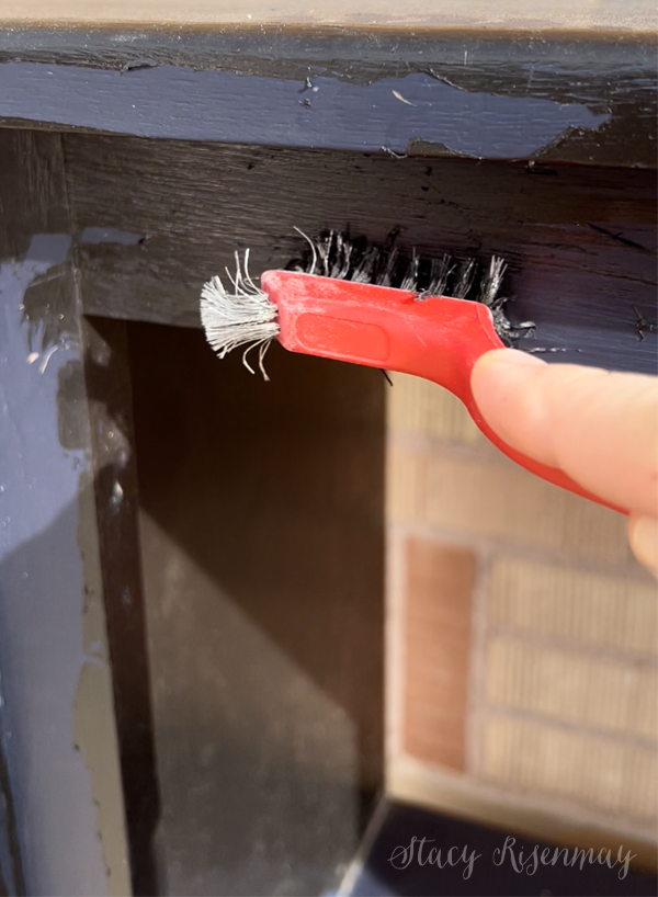 using a wire brush to remove old paint