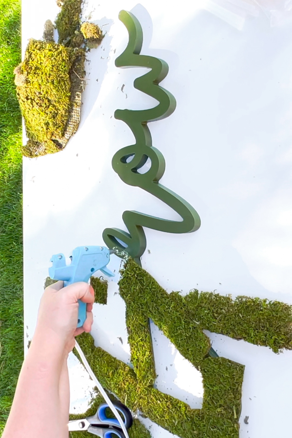 gluing moss on sign