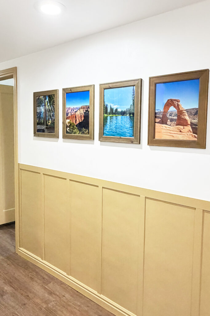 travel photos on wall in hallway with yellow wall trim