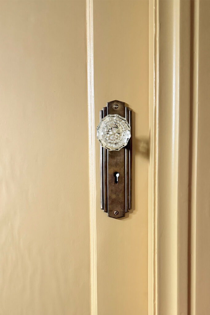 yellow door with antique door knob