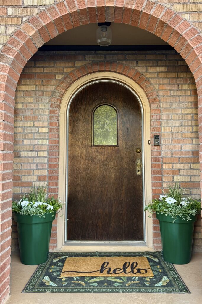 front porch with green planters